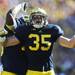 Michigan linebacker Joe Bolden celebrates after sacking UMass quarterback Mike Wegzyn in the second quarter against UMass at Michigan Stadium on Saturday. Melanie Maxwell I AnnArbor.com